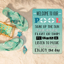 Load image into Gallery viewer, Rustic Welcome to Our Pool Sign styled on sandy beach-themed decor with flip-flops, a beach chair, and summer accessories.
