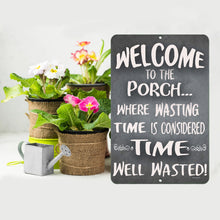 Load image into Gallery viewer, The Dyenamic Art Welcome to Our Porch sign displayed with rustic burlap-wrapped flower pots and a vintage-style watering can, enhancing its farmhouse aesthetic.

