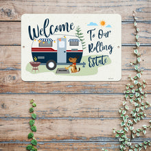 Load image into Gallery viewer, Detailed view of the Welcome to Our Rolling Estate Metal Sign – Retro camper design with a dog and outdoor scene.
