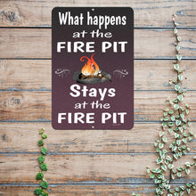 Load image into Gallery viewer, Rustic &quot;What Happens at the Fire Pit Stays at the Fire Pit&quot; metal sign displayed on a wooden fence, creating the perfect backyard, patio, or camping atmosphere.
