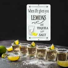 Load image into Gallery viewer, The When Life Gives You Lemons Metal Sign displayed in a fun margarita-inspired setting with tequila shots, limes, and a festive party atmosphere, ideal for home bars and entertainment spaces.
