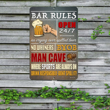 Load image into Gallery viewer, The Bar Rules Metal Sign displayed outdoors on a wooden fence with greenery, showcasing its rustic style and humorous bar-related quotes. A great addition to backyard bars and patios.

