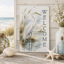 Load image into Gallery viewer, Decorative sign with a white egret and 'Welcome' text, surrounded by beach decor on a wooden surface.
