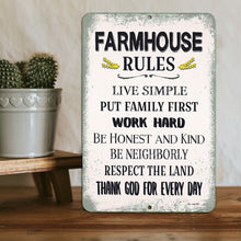 Load image into Gallery viewer, A rectangular metal sign with a distressed white background and a light blue-gray border, featuring the text 'FARMHOUSE RULES' and a list of farm-themed proverbs. The sign is displayed on a wooden surface next to a potted cactus.
