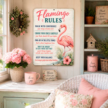 Load image into Gallery viewer, Flamingo Rules metal sign displayed in a bright cottage-style room with coastal décor and pink floral accents
