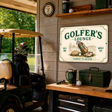 Load image into Gallery viewer, A decorative rectangular metal sign reading 'GOLFER'S LOUNGE' hangs on a gray wall in a golf-themed room. The sign features an illustration of a golf bag, clubs, and golf balls, with the phrases 'TEE IT HIGH' and 'WATCH IT FLY' and 'FAIRWAY TO HEAVEN' at the bottom.
