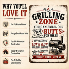 Load image into Gallery viewer, A vintage-style metal sign with a distressed cream background featuring the text 'Grilling Zone' and 'You Can Smell Our Butts For Miles,' along with an illustration of a pig wearing sunglasses and a smoking grill. The left side includes marketing callouts such as 'Why You'll Love It' with icons and text about humor, vintage style, durability, and outdoor use.

