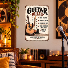Load image into Gallery viewer, Vintage Guitar Rules sign displayed on a wall in a warmly lit music room with guitars, rustic wood furnishings, and musician-inspired decor.

