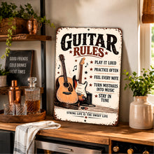 Load image into Gallery viewer, Retro guitar rules aluminum sign leaning on a wooden tabletop in a cozy home music space with guitars and warm decorative accents.
