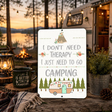 Load image into Gallery viewer, Funny camping metal sign displayed beside camper and campfire at cozy lakeside campsite
