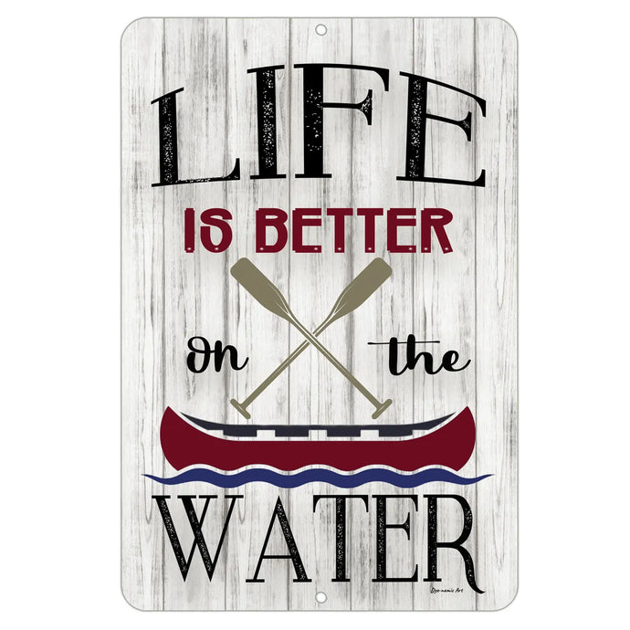 Rustic metal sign that reads “Life Is Better On the Water” with crossed oars and a red canoe, displayed on a whitewashed wood background