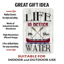 Load image into Gallery viewer, Product close-up of metal canoe sign with oars and “Life Is Better On the Water” text, highlighting aluminum quality and mounting holes
