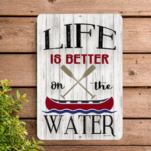 Load image into Gallery viewer, Life is Better on the Water metal sign on rustic wooden wall, lake house decor, canoe paddles design, aluminum outdoor sign
