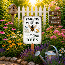 Load image into Gallery viewer, Pollinator-friendly bee garden sign displayed in blooming flower bed with white picket fence and cozy farmhouse garden decor
