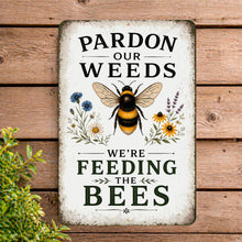 Load image into Gallery viewer, Decorative sign with a bee illustration and text about feeding bees on a wooden background.
