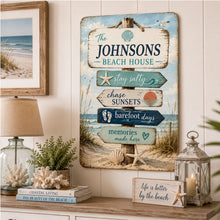 Load image into Gallery viewer, Personalized coastal beach house sign hanging in a cozy beach-themed living room
