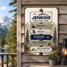 Load image into Gallery viewer, Custom family name mountain cabin sign displayed on a cabin wall overlooking a scenic mountain lake and forest landscape
