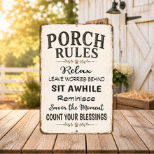 Load image into Gallery viewer, Porch Rules inspirational metal sign displayed on a farmhouse porch creating a peaceful outdoor retreat.
