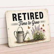 Load image into Gallery viewer, Retired Time to Grow aluminum retirement sign featuring flowers, butterflies, and vintage watering can artwork against wall
