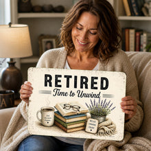Load image into Gallery viewer, Woman holding Retired Time to Unwind metal sign with vintage reading and lavender artwork
