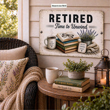 Load image into Gallery viewer, Retired Time to Unwind aluminum sign displayed on rustic shelf with books, blanket, and cozy reading decor
