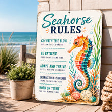 Load image into Gallery viewer, Seahorse Rules coastal metal sign displayed on a beach house porch overlooking the ocean
