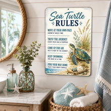 Load image into Gallery viewer, Sea Turtle Rules metal sign displayed in a coastal beach house bathroom with sea turtle decor and seaside accents
