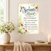 Load image into Gallery viewer, A rectangular decorative wall sign with the phrase “A Servant’s Heart” and floral artwork, displayed on a wall above a wooden table with flowers, a throw blanket, books, and a candle in a softly lit interior.
