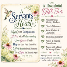 Load image into Gallery viewer, A decorative wall sign with floral artwork and inspirational text reading 'A Servant's Heart' on the left, alongside a matching gift message list on the right. The sign features cream background, green and navy lettering, pink flowers, and a small hummingbird illustration.
