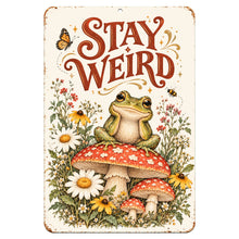 Load image into Gallery viewer, Stay Weird Frog Metal Sign featuring an adorable green frog sitting on a red mushroom surrounded by wildflowers, butterflies, and vintage cottagecore artwork.
