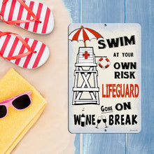 Load image into Gallery viewer, Dyenamic Art Swim at Your Own Risk Lifeguard Gone on Wine Break Metal Sign displayed with summer beach essentials. A playful addition to poolside bars, cabanas, and patios.
