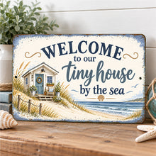 Load image into Gallery viewer, Coastal tiny house welcome sign leaning on a wooden table with seashells and beach-inspired accents in a bright seaside cottage.

