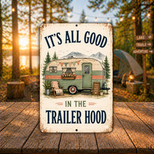 Load image into Gallery viewer, Trailer Hood camping sign displayed outdoors at a wooded campsite during sunset with the words It's All Good in the Trailer Hood
