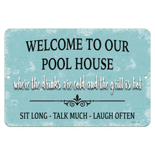 Load image into Gallery viewer, Welcome to Our Pool House Metal Sign by Dyenamic Art – A light blue, vintage-style metal sign with the phrase "Where the drinks are cold and the grill is hot." Great for poolside decor.
