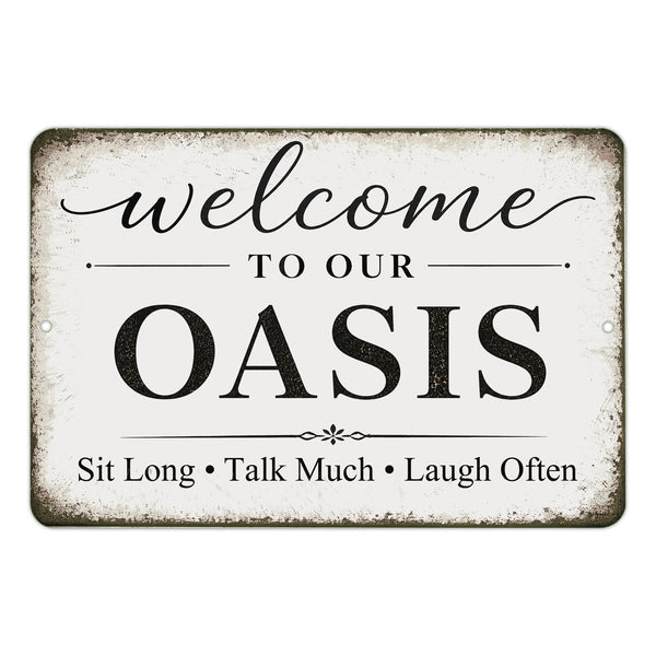 Decorative sign with text 'Welcome to our Oasis Sit Long Talk Much Laugh Often' on a white background