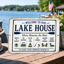 Load image into Gallery viewer, Welcome To Our Lake House metal sign displayed on a rustic lakeside porch overlooking the water
