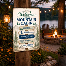 Load image into Gallery viewer, Welcome To Our Mountain Cabin metal sign displayed on an outdoor porch beside a fire pit
