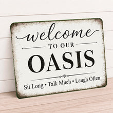 Load image into Gallery viewer, Decorative sign with 'Welcome to our Oasis' text on a wooden surface.
