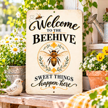 Load image into Gallery viewer, Decorative honeybee farmhouse sign displayed beside a rustic wooden surface, flowering plants, and sunny garden-inspired accents.
